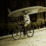 Belize surfer on a bike