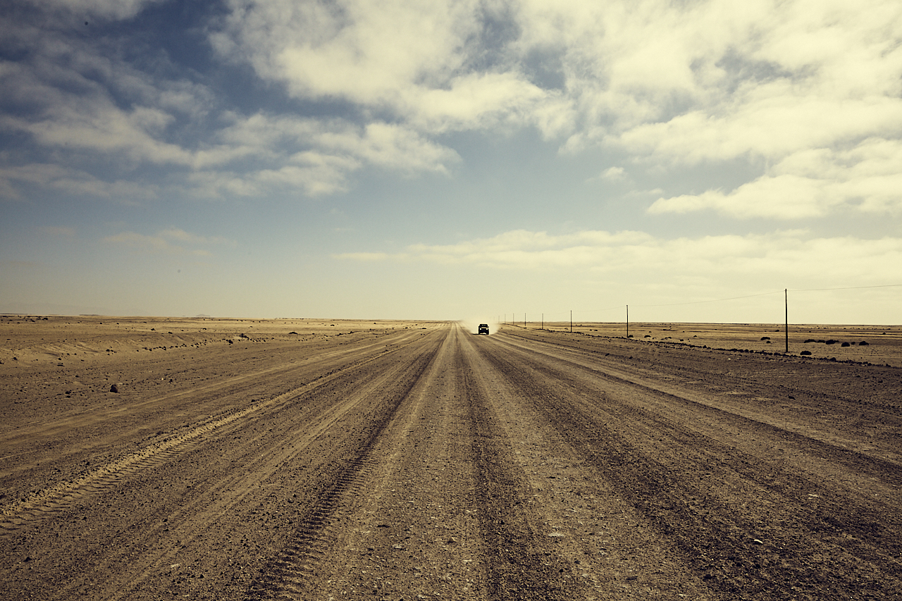 Distant car on gravel road